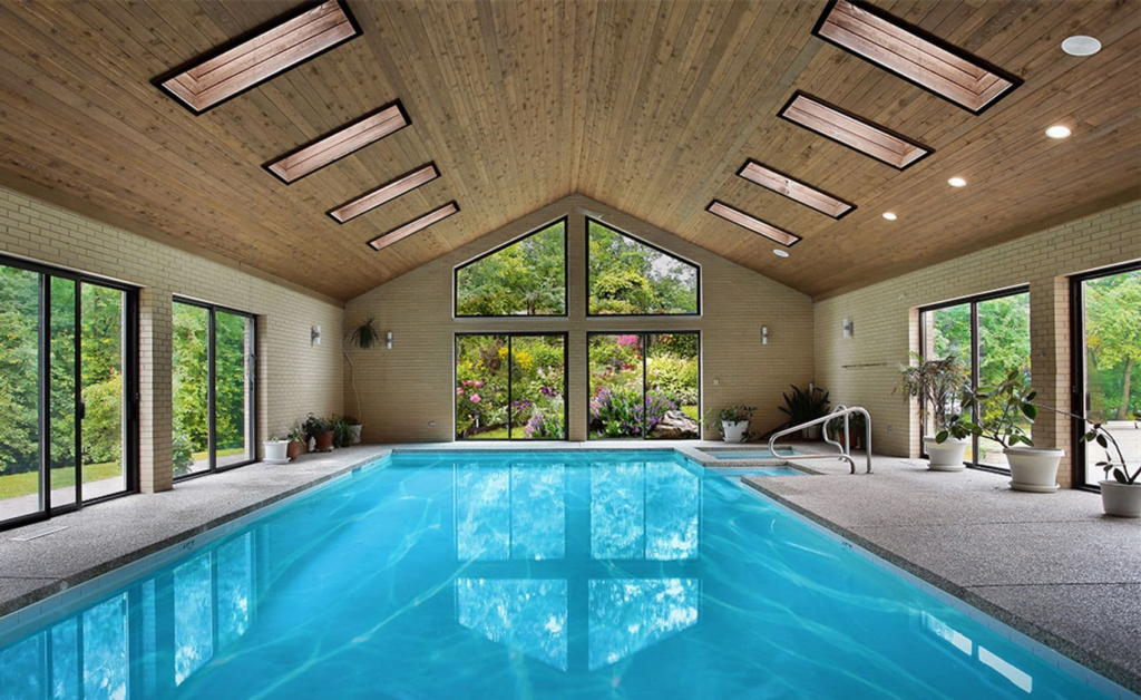 Glass windows and doors beside a swimming pool.